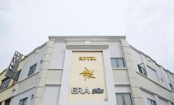 "a large white building with a gold star on the side and the words "" era plus "" written above it" at Era Plus Hotel