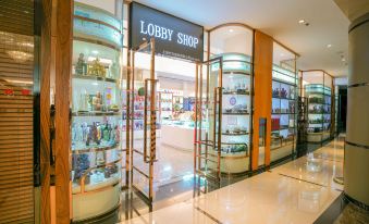 A store with numerous shelves is located in the front, alongside an entrance to another room at Ramada Plaza by Wyndham Shanghai Pudong Airport