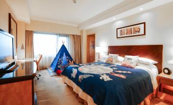 There is a large bed in the middle room with an orange and white color scheme at Radisson Collection Hotel, Yangtze Shanghai