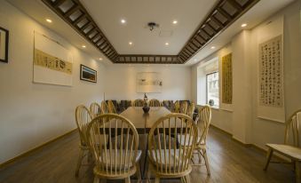 The dining area features a modern aesthetic with a large oval table and chairs at Hotel Blanche