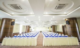 a large conference room with rows of chairs arranged in a semicircle , ready for a meeting or event at Golf Phu My Hotel