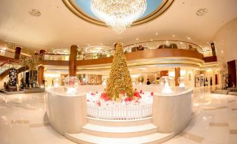 A spacious room featuring an intricate ceiling and a central chandelier is prepared for use at Grand Millennium Shanghai HongQiao