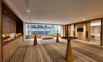 There is a room with large windows and tables in the middle, along with an area rug at Hyatt Place Shanghai Hongqiao CBD