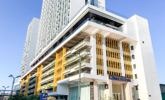 A spacious building with balconies on the side and an apartment located at one end at Landmark Vientiane Life Center