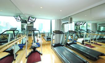 The gym, located in the middle of the hotel, is brightly illuminated with large windows at Bishop Lei International House