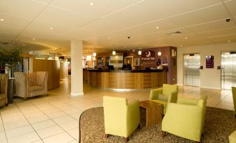 a hotel lobby with a reception desk and several chairs arranged in various positions , creating a welcoming atmosphere at Dublin Airport