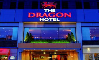 "a large hotel with a blue and red sign that says "" the dragon hotel "" in front" at The Dragon Hotel