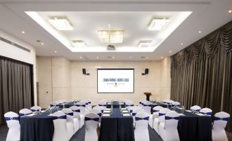 a large event room with tables and chairs arranged facing the front at Hisoar Hotel