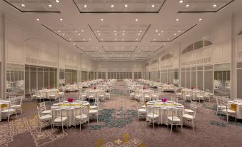 a large , empty banquet hall with multiple tables and chairs set up for a formal event at Dusit Thani Hua Hin