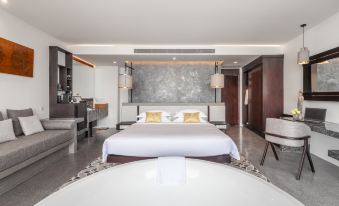 elegant and spacious bedroom with a king-sized bed, contemporary furniture, and artwork adorning the walls at Hotel Vellita Siem Reap