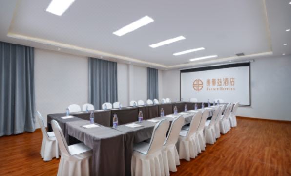 a large room arranged for an event with long tables and chairs positioned towards the front at Peony Hotel(Mudanyuan Subway Station)