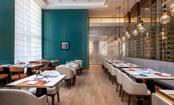 The blue wall in the restaurant provides a stunning contrast to the light wood paneling at LEFUQIANG BOYUE HOTEL