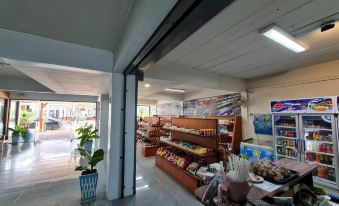 a grocery store with a variety of items for sale , including fruits , vegetables , and other food items at Phu nga Hotel