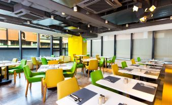 The restaurant has a dining room in the center with tables and chairs specifically designed for business luncheons at Holiday Inn Express Macau City Centre