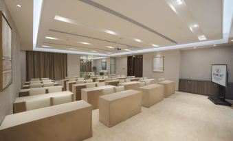 a large conference room with rows of chairs arranged in a semicircle , providing seating for attendees at Somerset Grand Central Dalian