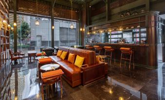The restaurant features an open concept design with tables, chairs, and ceiling windows at Guangzhou Tianhe Taikoohui - Coffee Rupin Hotel