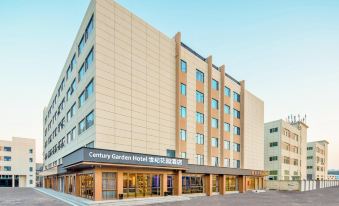 The front entrance of a hotel is located in an urban setting, surrounded by tall glass and steel buildings at Century Garden Hotel