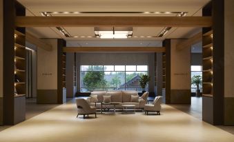 a large , well - lit room with a couch and chairs arranged in a lounge - like setting at Lahan Hotel Jeonju