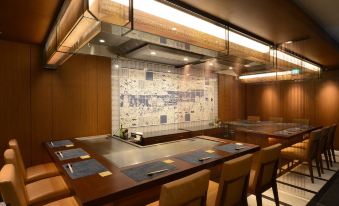 a modern , minimalist restaurant with wooden walls and ceiling , large windows , and a bar area at Kobe Portopia Hotel