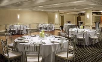 a large banquet hall filled with round tables and chairs , ready for a formal event at Grand Palms Spa & Golf Resort