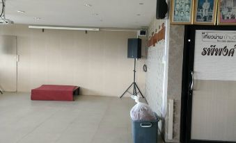 a room with a trash can and a trash bag in front of a speaker at Rapeepong Resort Nanthai