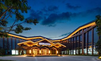 The hotel's front entrance is illuminated at night with a sign above it at Steigenberger Chengdu