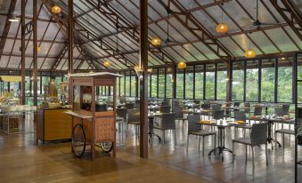 a dining area with a variety of chairs and tables , as well as a vending machine at Jsi Resort