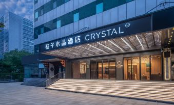 The entrance to a hotel is adorned with an illuminated sign above its glass front door at Crystal Orange Beijing Shangdi Zhongguancun Software Park Hotel