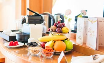 A table is set with plates and bowls, with an assortment of items in the center at Yyldyz