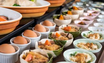 a buffet table filled with a variety of food items , including bowls , plates , and cups at HOTEL MYSTAYS Utsunomiya