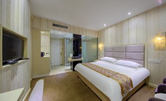 The middle room features a spacious bed, an attached bathroom, and a sitting area adjacent to it at Fortune Hotel