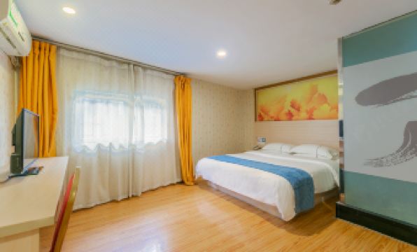 The apartment features a bedroom with hardwood floors, white walls, and blue curtains on the windows at Seven Orange Hotel (Guangzhou Railway Station)