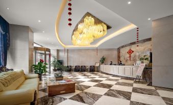 a modern hotel lobby with a check - in desk , seating area , and a large chandelier hanging from the ceiling at Mediterranean Hotel