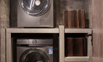 The laundry room will have two washing machines and an open shelf available for use in the upcoming months at Manxin Hotel