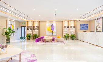 A spacious room with white furniture and tables arranged in the center, featuring an open concept design at Lavande Hotel (Beijing Changyang Metro Station)