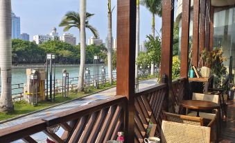 a balcony overlooking a body of water , with several chairs and tables placed on the deck for outdoor dining at Swan Hotel