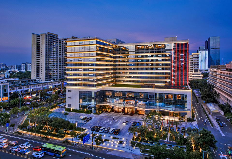 At night, a large building in the middle is illuminated by streetlights, offering an outside view at Hainan Grand Hotel