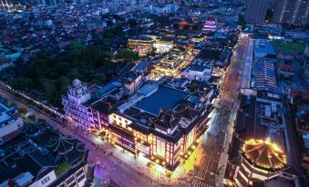 At night, an aerial view of a well-lit city with buildings surrounding the streets at Autoongo Hotel On the Bund, Shanghai