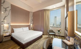 a modern hotel room with a large window offering a city view , white bed , and comfortable seating area at Cititel Penang