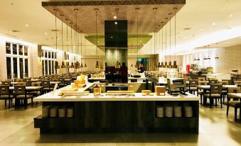 a large kitchen with a long counter and several bottles hanging from the ceiling above it at J Resort