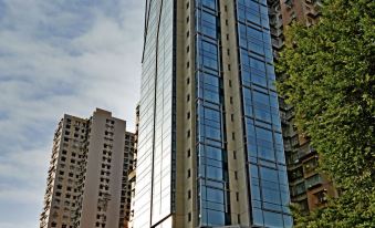 A tall building with numerous windows located beside another skyscraper at GreeneryInn