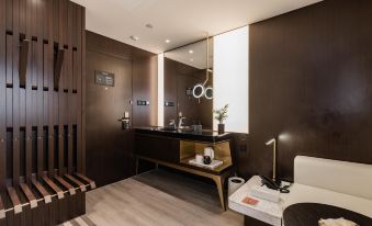 The modern bathroom features a large mirror and a wood-paneled accent wall in the center at CitiGO Hotel Jing'an Shanghai