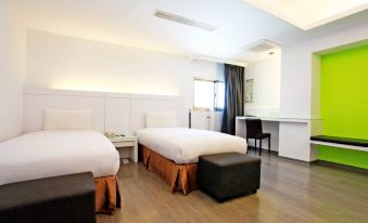 a modern hotel room with two beds , white walls , and wooden floors , including a kitchenette and a counter at Yes Hotel