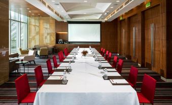 a long dining table set up for a formal event , with multiple chairs arranged around it at Grand Hyatt Manila