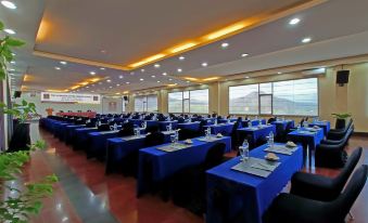 a large conference room with multiple rows of tables and chairs arranged for a meeting or event at The Jayakarta Suites Komodo Flores