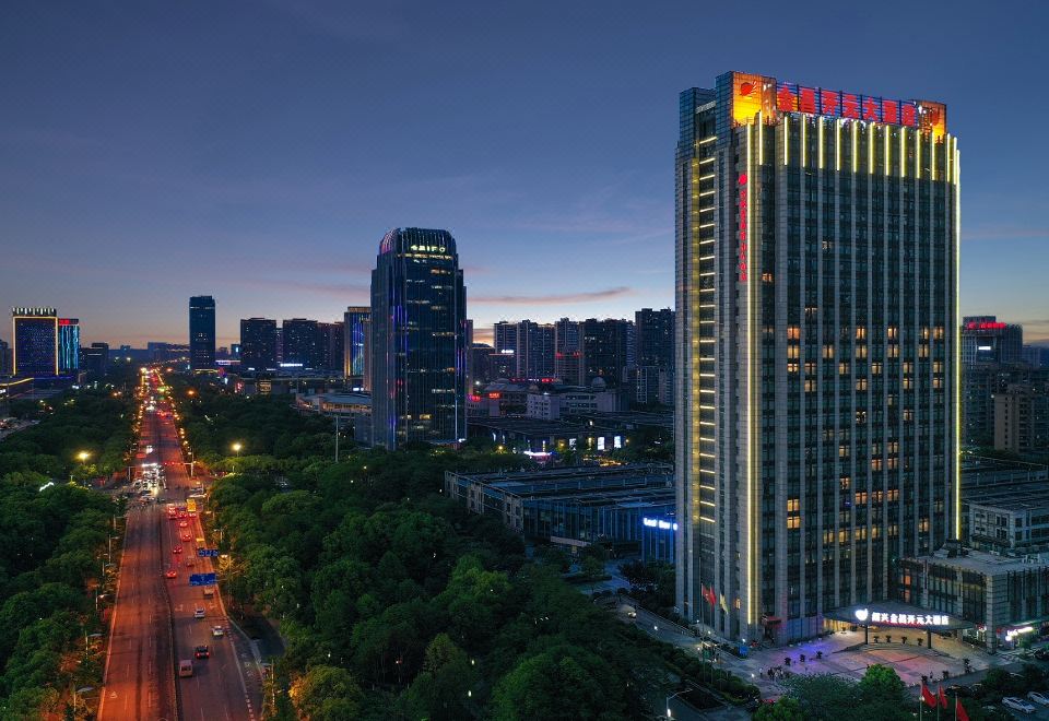 A city's illuminated skyline at night, with buildings on both sides at Maision New Century Hotel Keqiao Shaoxing