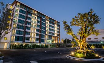 At night, there is a large apartment building with a complex behind it at Orion Hotel & Residence Bangna