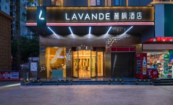 "At night, a hotel entrance is illuminated with a sign that says ""welcome"" above it" at Lavande Hotel (Kunming Xishan Wanda Plaza Railway Station)