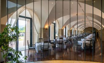 a large dining room with multiple tables and chairs arranged for a group of people at Hakone Hotel