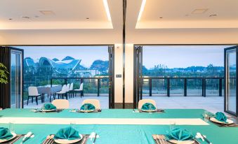The dining room features large windows and tables set for ten people in the center at WING HOTEL